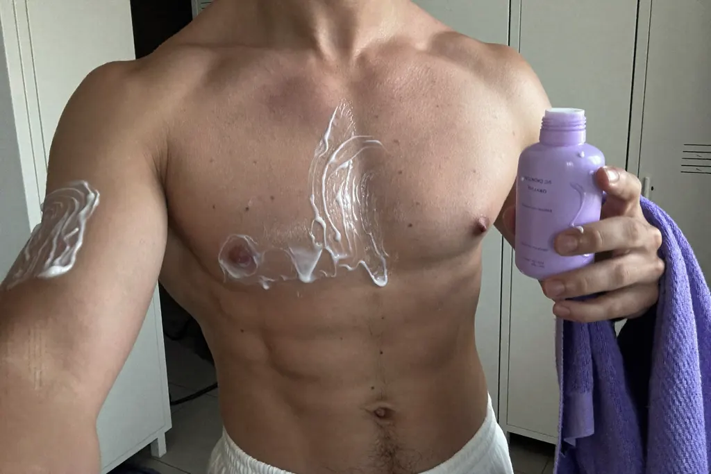 Hombre joven aplicándose un gel para los granos